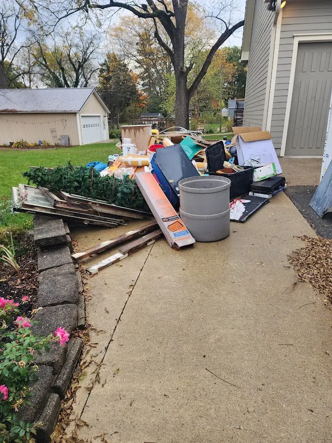 Dumpster being loaded with debris for Roofing Dumpster Rental in Pulaski